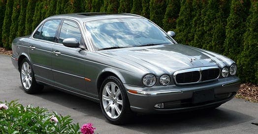 grey Jaguar parked in driveway